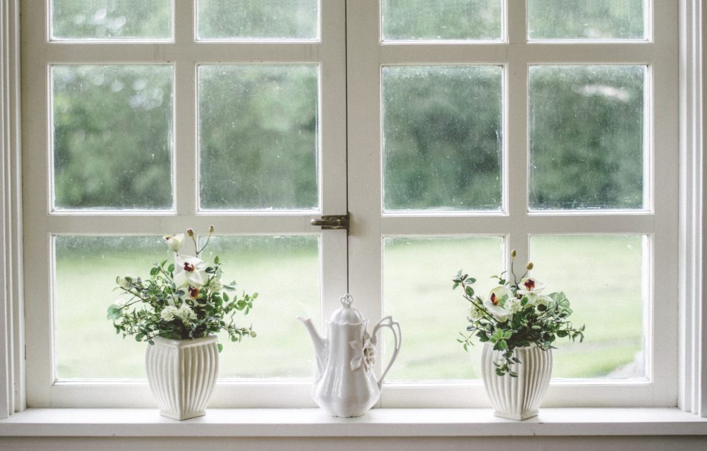 make your window space lovely by adding ornaments like these, this picture is of a window with flowers and a jug on it