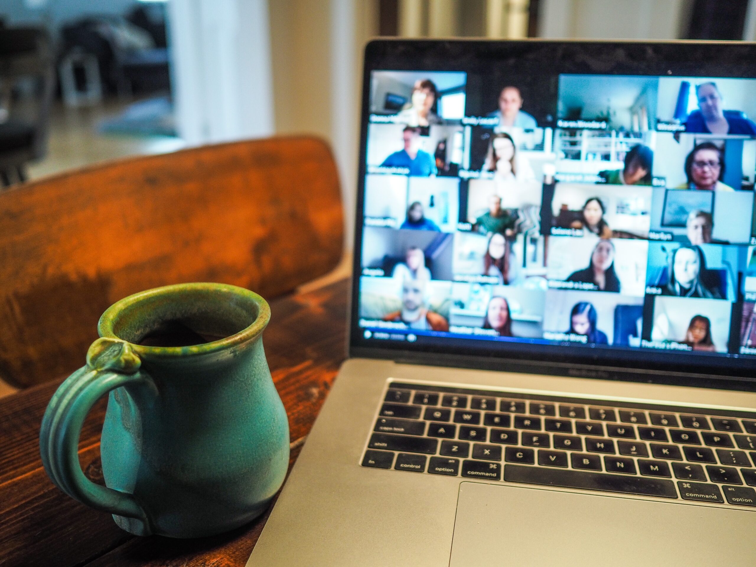 cup of tea next to a laptop taking a zoom call