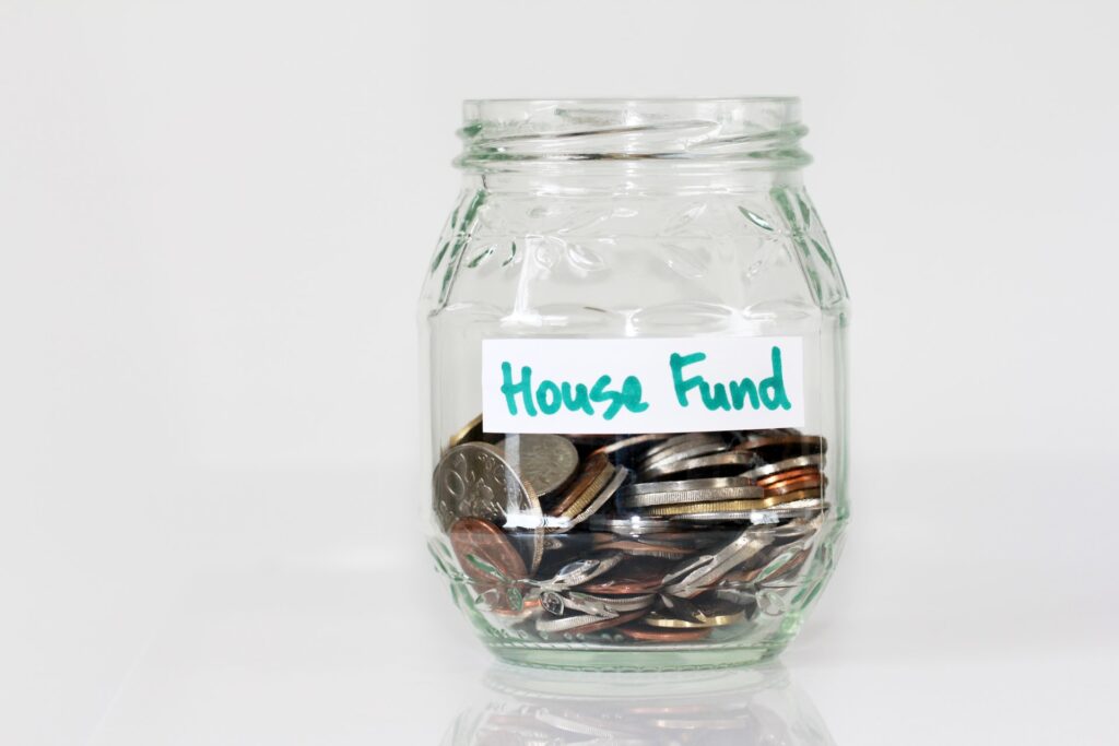 jam jar with label of house fund filled with coins