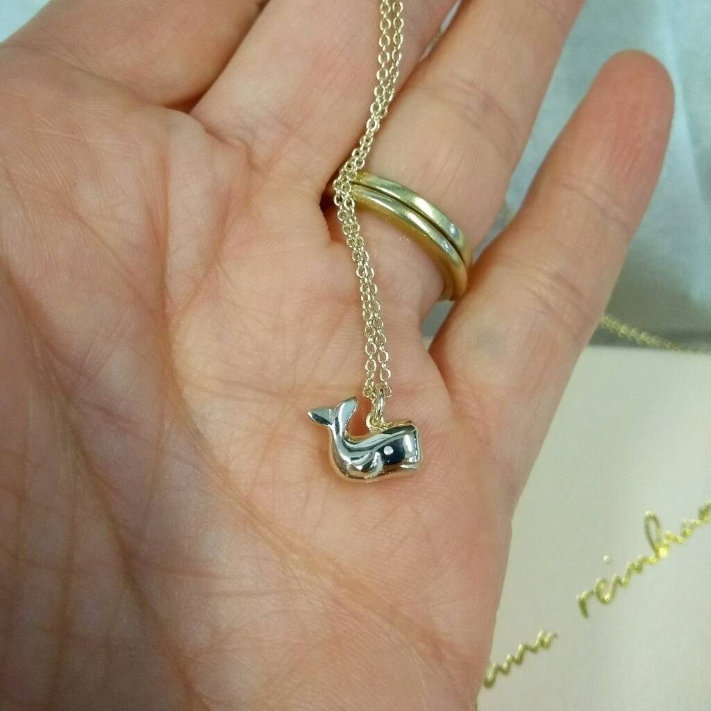 Whale necklace in model's hand