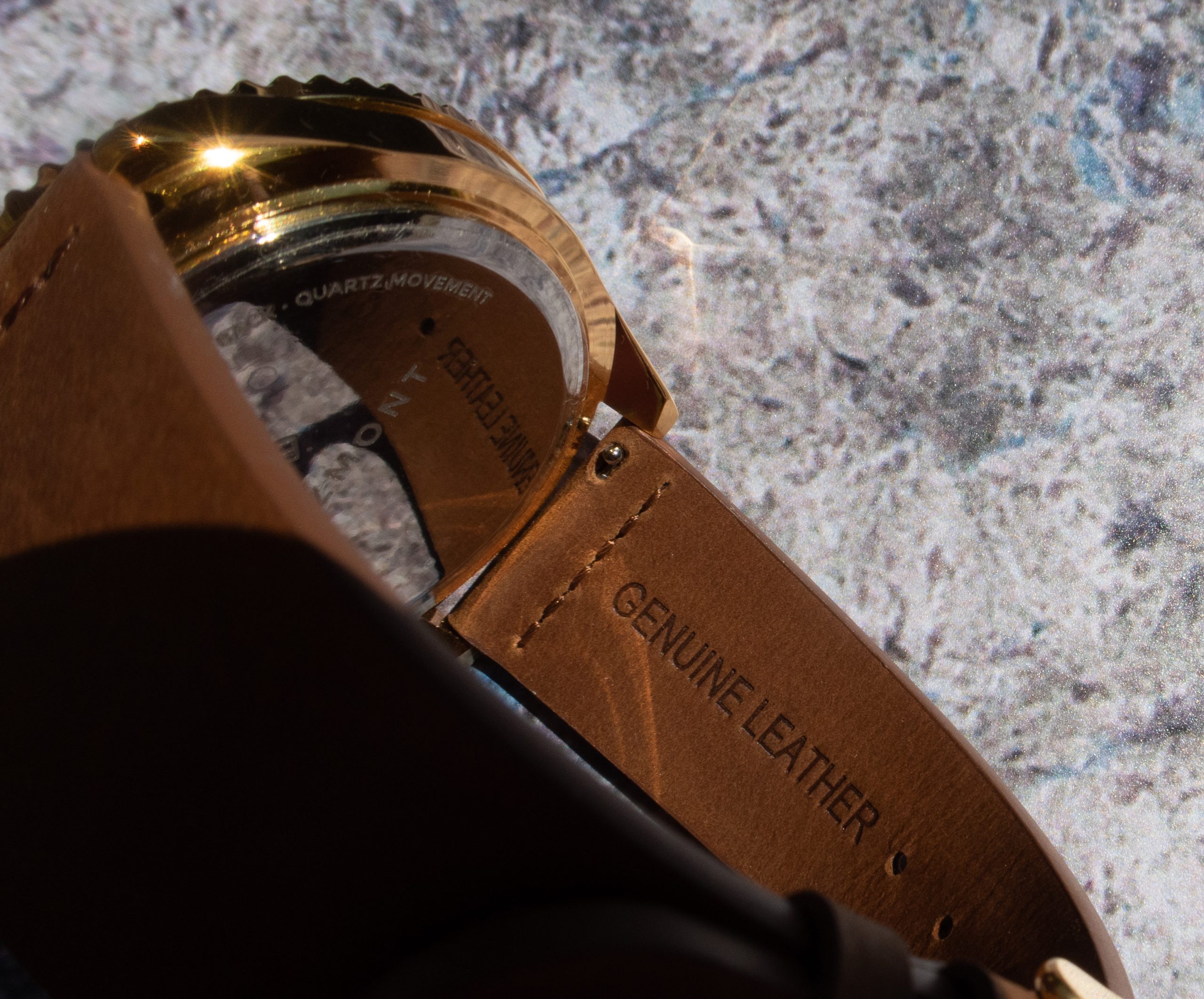 genuine leather stamped into the strap