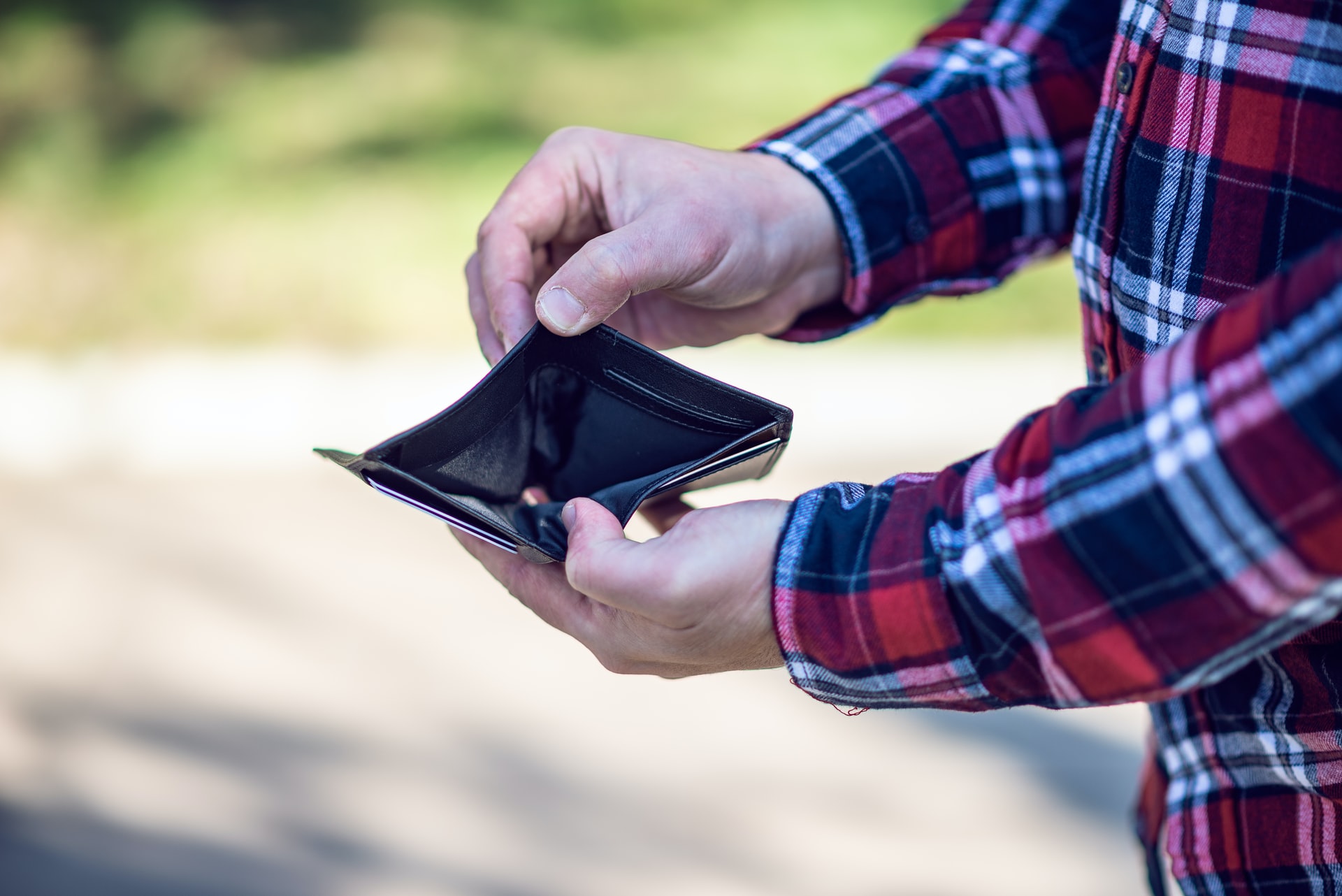 man holding empty wallet wide open