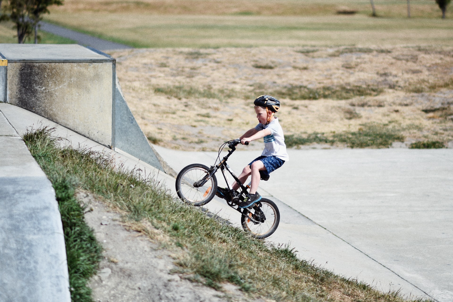 child riding a bike and wearing a helmet