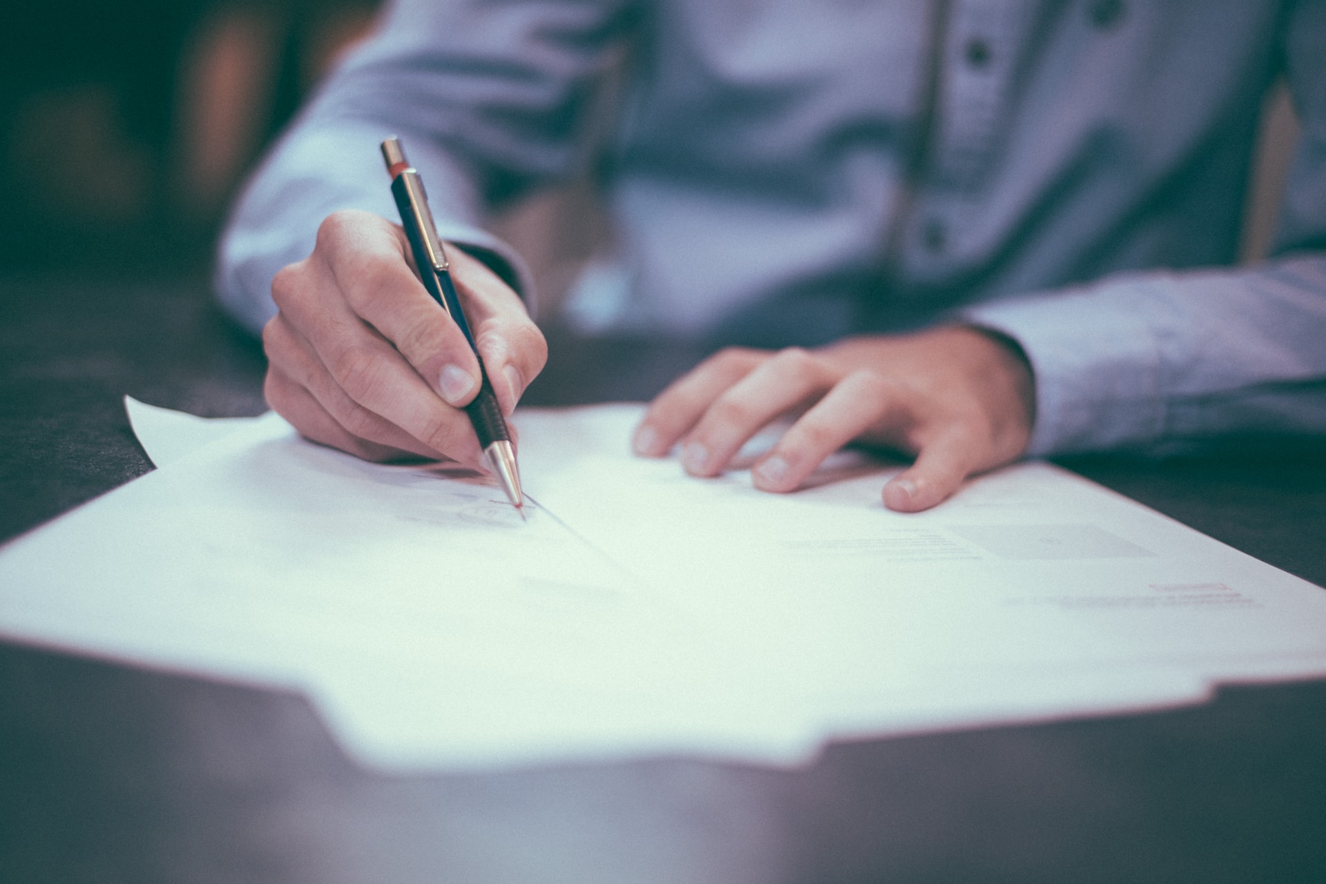 person sitting exam, can see hands and paper