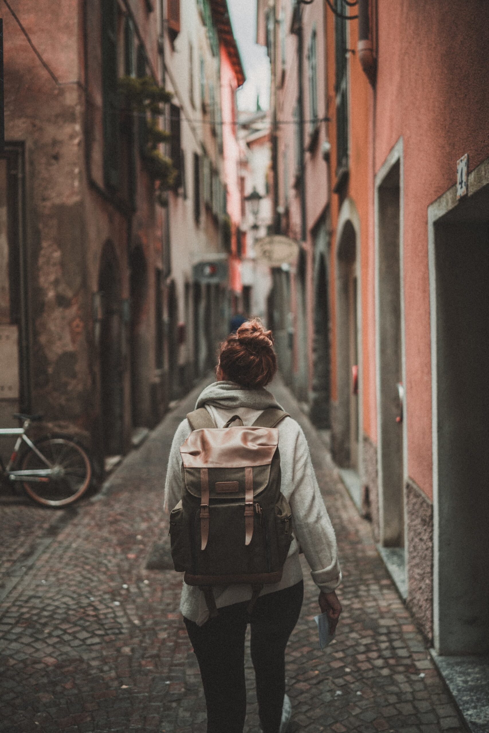woman wearing a backpack, exploring a new city