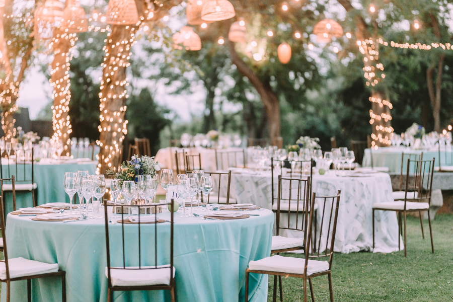 Wedding Blog Post Ideas outdoor wedding set up with lights and dressed chairs