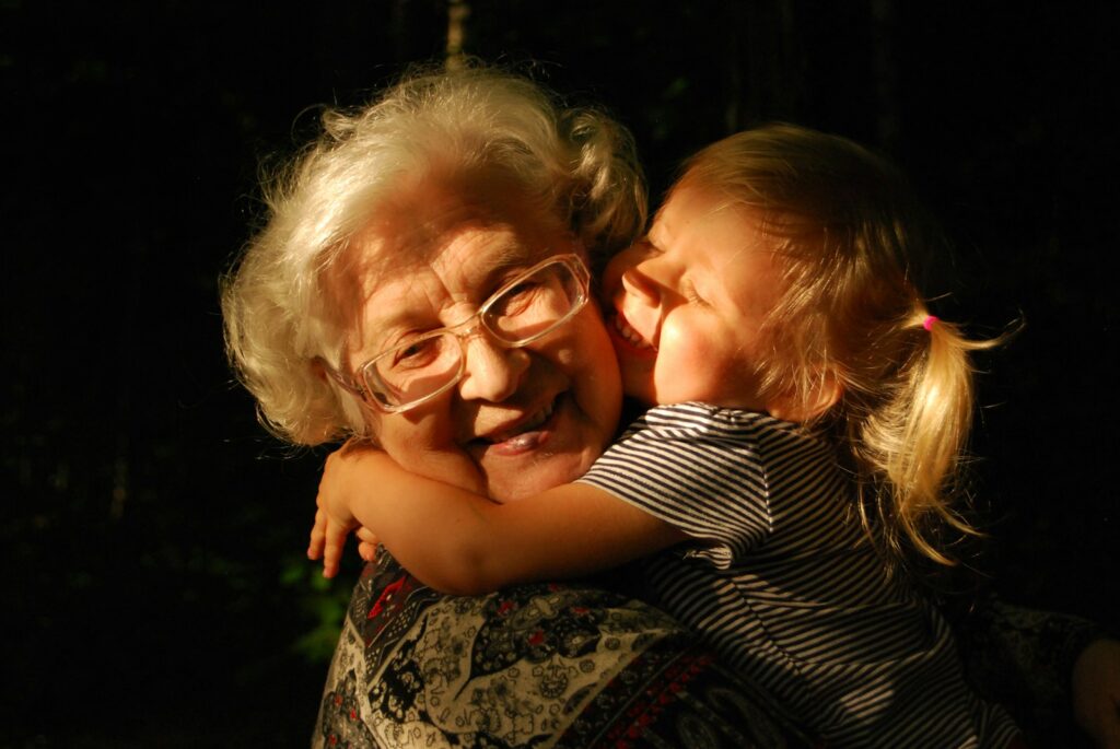 woman in black and white striped shirt hugging girl in black and white striped shirt Grandparent's Day